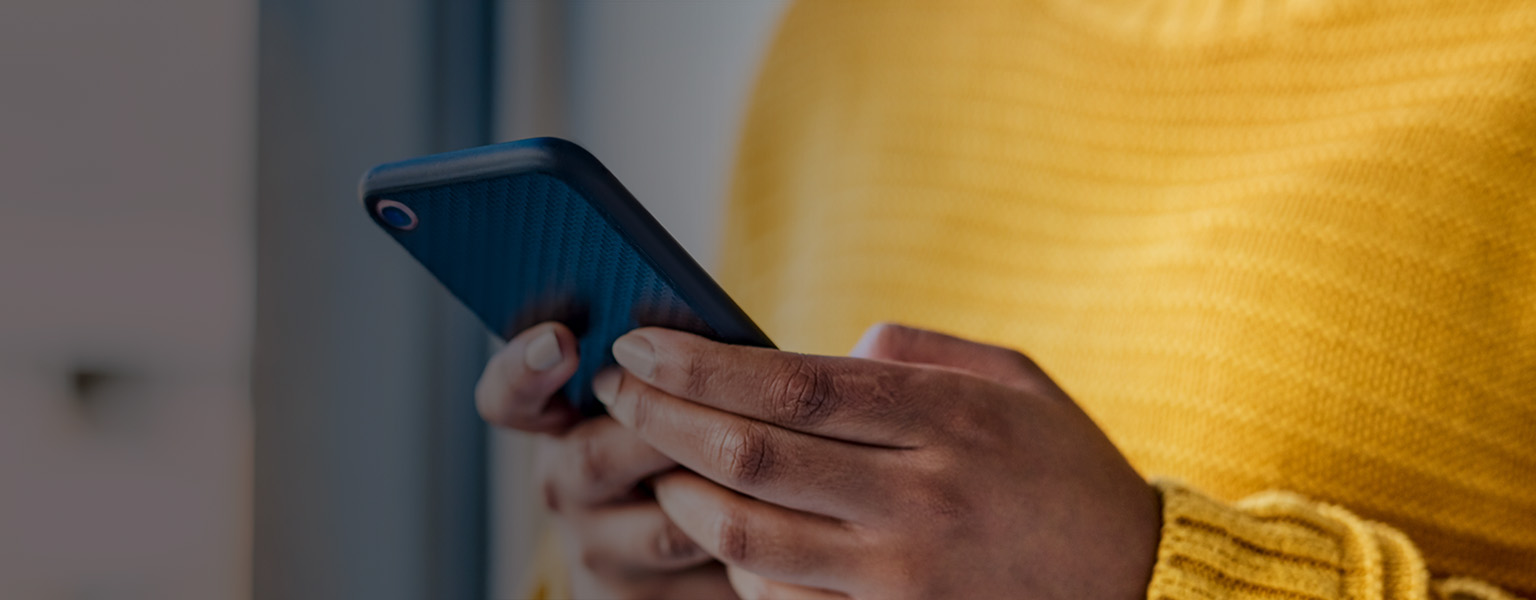 Close up image of someone using an iphone.